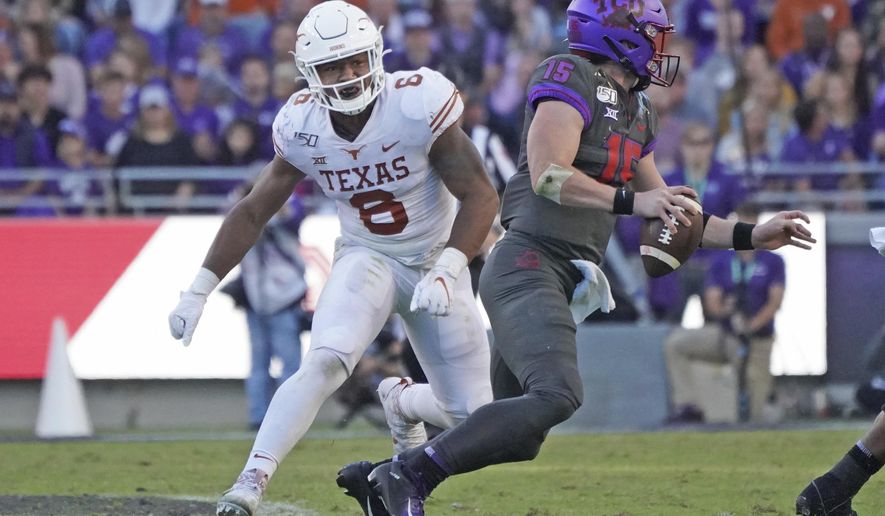 FILE - In this Oct. 26, 2019, file photo, Texas linebacker Juwan Mitchell (6) pursues TCU quarterback Max Duggan during the second half of an NCAA college football game in Fort Worth, Texas. The two teams meet again this week. TCU won only six of its last 39 meetings against Texas when they were still together in the old Southwest Conference through the 1995 season. Coach Gary Patterson and TCU have matched that win total in eight games since joining the Longhorns in the Big 12 less than a decade ago. (AP Photo/Louis DeLuca, File)