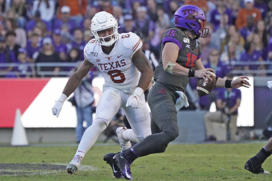 FILE - In this Oct. 26, 2019, file photo, Texas linebacker Juwan Mitchell (6) pursues TCU quarterback Max Duggan during the second half of an NCAA college football game in Fort Worth, Texas. The two teams meet again this week. TCU won only six of its last 39 meetings against Texas when they were still together in the old Southwest Conference through the 1995 season. Coach Gary Patterson and TCU have matched that win total in eight games since joining the Longhorns in the Big 12 less than a decade ago. (AP Photo/Louis DeLuca, File)