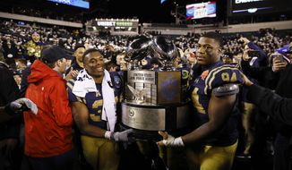 FILE - In this Saturday, Dec. 14, 2019, file photo, Navy midshipmen carry the Commander in Chief&#x27;s trophy after defeating Army in an NCAA college football game, in Philadelphia. Navy won 31-7. After weeks and weeks of practice, Air Force will finally take the field Saturday, Oct. 3, 2020, against Navy at Falcon Stadium. The two service academies renew their rivalry as they compete for the coveted Commander-in-Chief&#x27;s Trophy. (AP Photo/Matt Rourke, File)
