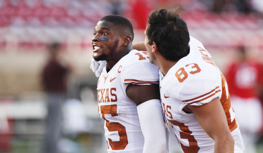 Texas defensive back Chris Brown and wide receiver Kai Money celebrate their win over Texas Tech after an NCAA college football game against Texas Tech, Saturday Sept. 26, 2020, in Lubbock, Texas. (AP Photo/Mark Rogers)