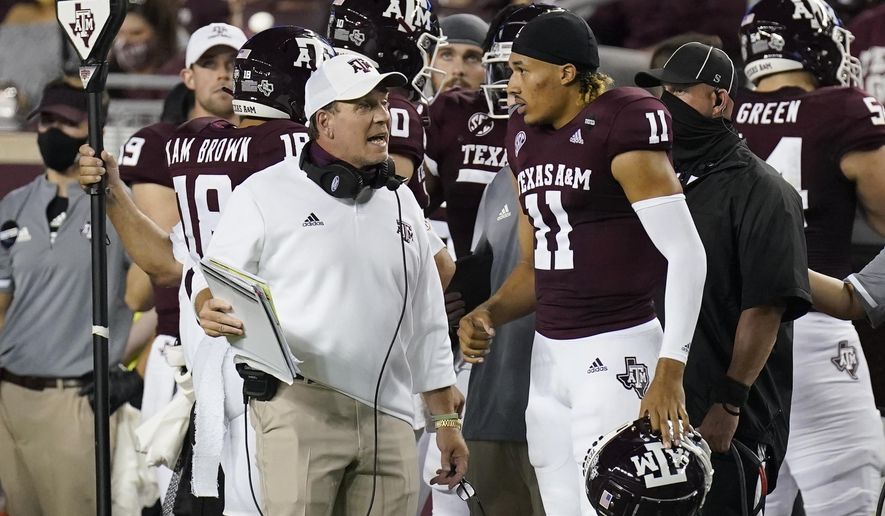 Texas A&amp;amp;M coach Jimbo Fisher, left, talks with quarterback Kellen Mond (11) during the first half of an NCAA college football game against Vanderbilt Saturday, Sept. 26, 2020, in College Station, Texas. (AP Photo/David J. Phillip)