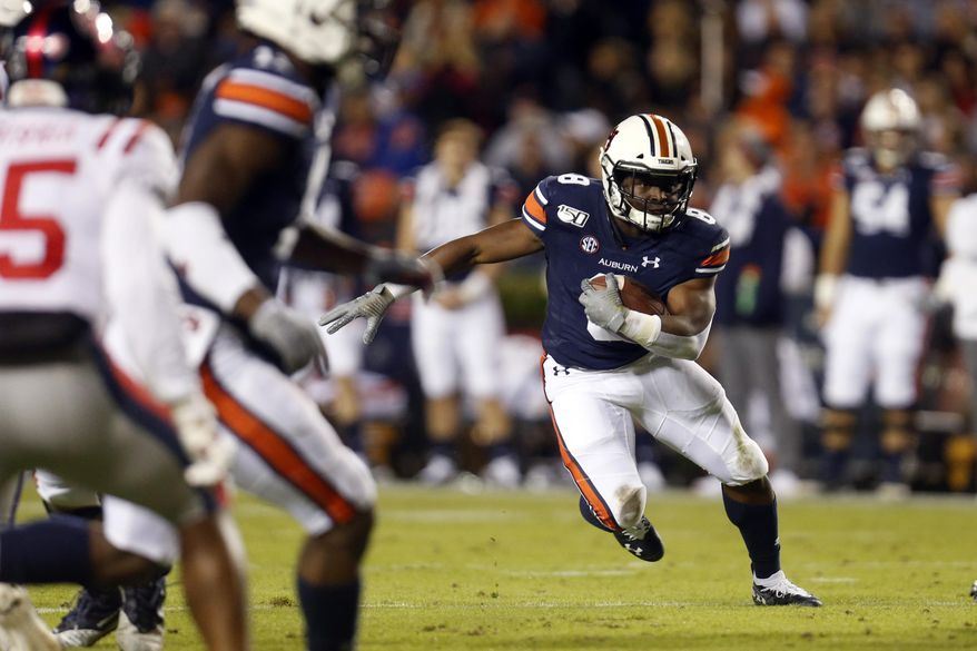 FILE - In this Nov. 2, 2019, file photo, Auburn running back Shaun Shivers (8) carries the ball during the first half of an NCAA college football game against Mississippi in Auburn, Ala. The Auburn Tigers once seemed virtual locks to have at least one 1,000-yard rusher every season. (AP Photo/Butch Dill, File)