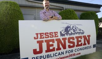 Jesse Jensen, the Republican challenging Rep. Kim Schrier in Washington&#x27;s 8th Congressional District, poses for a photo outside his campaign office Tuesday, Sept. 29, 2020, in Pacific, Wash. Jensen is an Army veteran from Bonney Lake who did four combat tours in Afghanistan.  (AP Photo/Elaine Thompson)