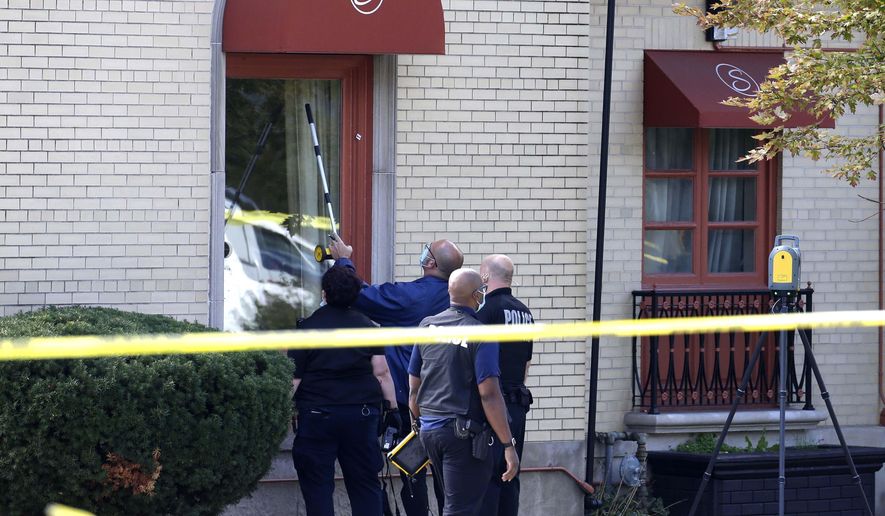 Evidence is gathered after reports of a shooting at Serenity Funeral Home Wednesday, Sept. 30, 2020 in Milwaukee. Several people have been shot and wounded in an apparent drive-by shooting outside the funeral home, but all are expected to survive. Acting Police Chief Michael Brunson said all of the injured are expected to survive and were in stable condition Wednesday at a local hospital. (Rick Wood /Milwaukee Journal-Sentinel via AP)