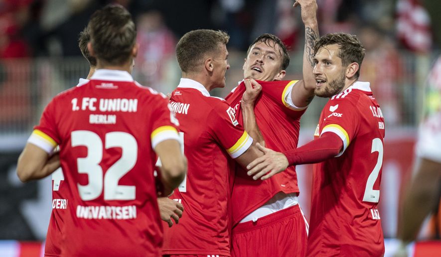 Union's Max Kruse, second right, reacts with teammates after scoring, during the German Bundesliga soccer match between FC Union Berlin and FSV Mainz, at the Stadion An der Alten Forsterei, in Berlin, Friday, Oct. 2, 2020. (Andreas Gora/dpa via AP)