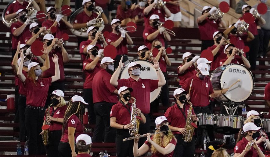 FILE - In this Saturday, Sept. 12, 2020 file photo, a reduced size Oklahoma band performs in the stands in the second half of an NCAA college football game against Missouri State in Norman, Okla. Marching bands, part of the game since its beginning more than a century ago, are idled or toned down across the country. (AP Photo/Sue Ogrocki, File)