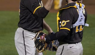 San Diego Padres relief pitcher Craig Stammen, left, is congratulated by catcher Austin Nola after the team&#39;s 7-0 victory over the Oakland Athletics in baseball game in Oakland, Calif., Friday, Sept. 4, 2020. (AP Photo/Tony Avelar)