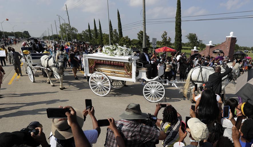 FILE - In this June 9, 2020 file photo, George Floyd's funeral procession arrives at Houston Memorial Gardens cemetery, in Pearland, Texas. During George Floyd's June burial at a cemetery in the Houston suburb of Pearland, authorities deployed hundreds of law enforcement personnel, including six sniper teams and highly trained members of the Border Patrol, due in part to what they described as social media chatter and public anxiety about possible protests and riots, according to documents obtained by the American Civil Liberties Union of Texas. (AP Photo/Eric Gay File)