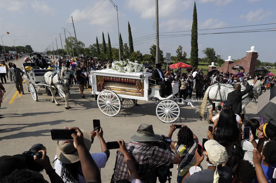 FILE - In this June 9, 2020 file photo, George Floyd's funeral procession arrives at Houston Memorial Gardens cemetery, in Pearland, Texas. During George Floyd's June burial at a cemetery in the Houston suburb of Pearland, authorities deployed hundreds of law enforcement personnel, including six sniper teams and highly trained members of the Border Patrol, due in part to what they described as social media chatter and public anxiety about possible protests and riots, according to documents obtained by the American Civil Liberties Union of Texas. (AP Photo/Eric Gay File)