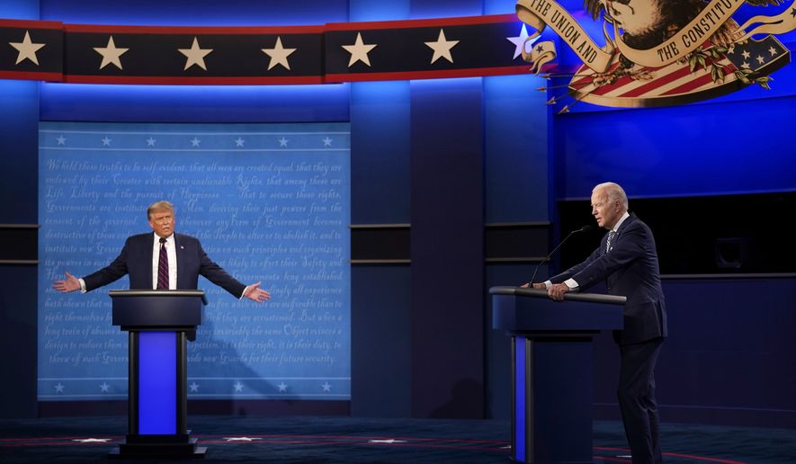 President Donald Trump, left, reacts as former Vice President Joe Biden speaks during the first presidential debate Tuesday, Sept. 29, 2020, at Case Western University and Cleveland Clinic, in Cleveland, Ohio. (AP Photo/Julio Cortez)