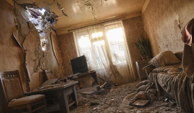 Damages are seen inside an apartment in a residential area after shelling during a military conflict in self-proclaimed Republic of Nagorno-Karabakh, Stepanakert, Azerbaijan, Saturday, Oct. 3, 2020. The fighting is the biggest escalation in years in the decades-long dispute over the region, which lies within Azerbaijan but is controlled by local ethnic Armenian forces backed by Armenia. (David Ghahramanyan/NKR InfoCenter PAN Photo via AP)