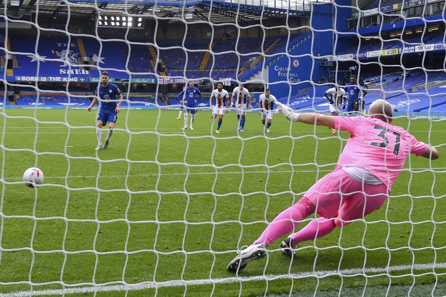 Chelsea&#39;s Jorginho, left, scores his side&#39;s third goal on a penalty kick during an English Premier League soccer match between Chelsea and Crystal Palace at Stamford Bridge stadium in London, Saturday, Oct. 3, 2020. (Mike Hewitt/ Pool via AP)