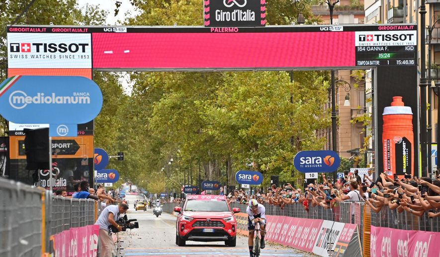 Italy's Filippo Ganna crosses the finish line to win the opening stage of the Giro d'Italia, tour of Italy, cycling race, an individual time trial from Monreale to Palermo, Italy, Saturday, Oct. 3, 2020. Individual Time Trial's reigning world champion Filippo Ganna won the stage and took the pink jersey of the race overall leader. (Gian Mattia D'Alberto/LaPresse via AP)
