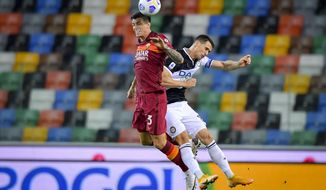 Roger Ibañez da Silva, left, and Kevin Lasagna fight for the ball during the Serie A soccer match between Udinese and Roma, at the Dacia Arena in Udine, Italy, Saturday, Oct. 3, 2020. (Fabio Rossi/LaPresse via AP)