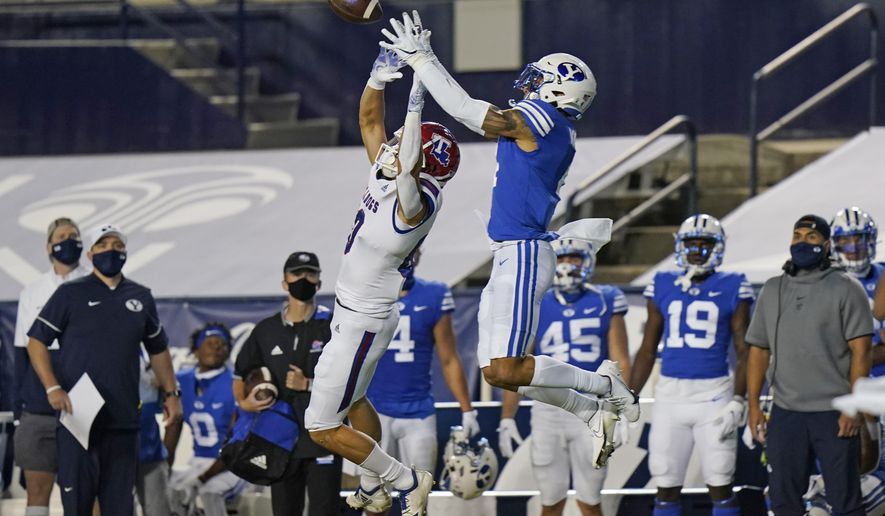 BYU defensive back Troy Warner, right, incepts a pass intended for Louisiana Tech wide receiver Griffin Hebert, left, during the first half of an NCAA college football game Friday, Oct. 2, 2020, in Provo, Utah. (AP Photo/Rick Bowmer, Pool)