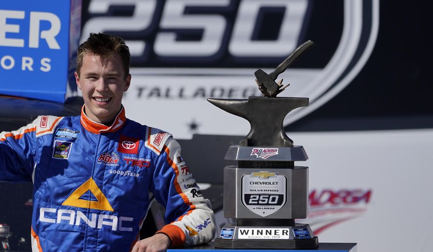 Raphael Lessard celebrates in Victory Lane after winning the NASCAR Truck series auto race at Talladega Superspeedway, Saturday, Oct. 3, 2020, in Talladega, Ala. (AP Photo/John Bazemore)