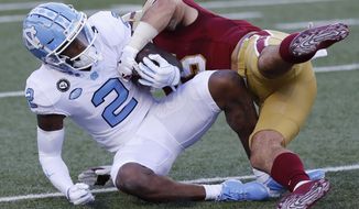 Boston College linebacker Isaiah McDuffie tackles North Carolina wide receiver Dyami Brown (2) during the first half of an NCAA college football game, Saturday, Oct. 3, 2020, in Boston. (AP Photo/Michael Dwyer)
