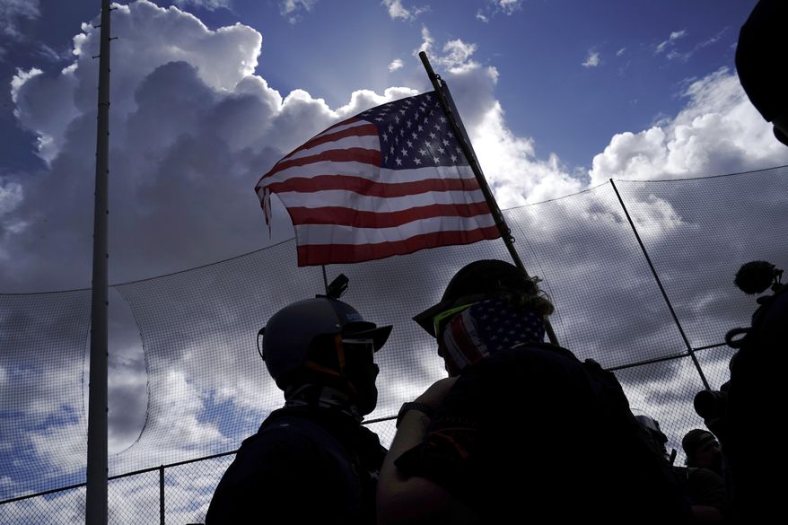 A member of the Proud Boys (right) tries to get a counterprotester to leave a rally by members of the Proud Boys and other right-wing demonstrators in Portland, Ore., on Saturday, Sept. 26, 2020. (AP Photo/John Locher) **FILE**