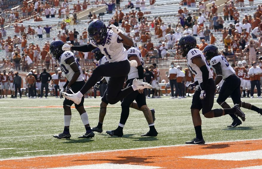 TCU cornerback Tre'Vius Hodges-Tomlinson (1) celebrates with teammates after TCU recovered a Texas fumble during the second half of an NCAA college football game, Saturday, Oct. 3, 2020, in Austin, Texas. (AP Photo/Eric Gay)