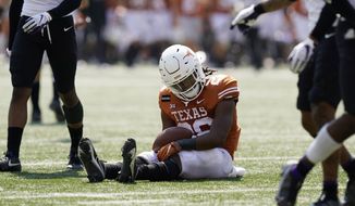 Texas running back Keaontay Ingram (26) reacts after he was stopped short of a touchdown on a run against TCU during the second half of an NCAA college football game, Saturday, Oct. 3, 2020, in Austin, Texas. (AP Photo/Eric Gay)