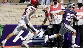 Kansas State running back Deuce Vaughn (22) beats Texas Tech defensive back Thomas Leggett (16) into the end zone to score a touchdown during the first half of an NCAA college football game Saturday, Oct. 3, 2020, in Manhattan, Kan. (AP Photo/Charlie Riedel)