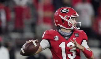 Georgia quarterback Stetson Bennett looks for a receiver during the second half of the team&#39;s NCAA college football game against Auburn, Saturday, Oct. 3, 2020, in Athens, Ga. (AP Photo/Brynn Anderson)