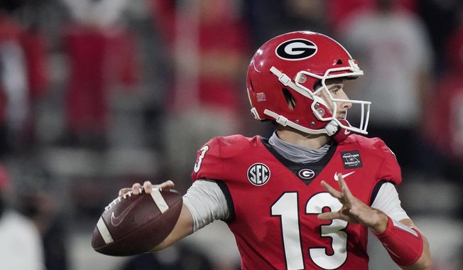Georgia quarterback Stetson Bennett looks for a receiver during the second half of the team&#x27;s NCAA college football game against Auburn, Saturday, Oct. 3, 2020, in Athens, Ga. (AP Photo/Brynn Anderson)