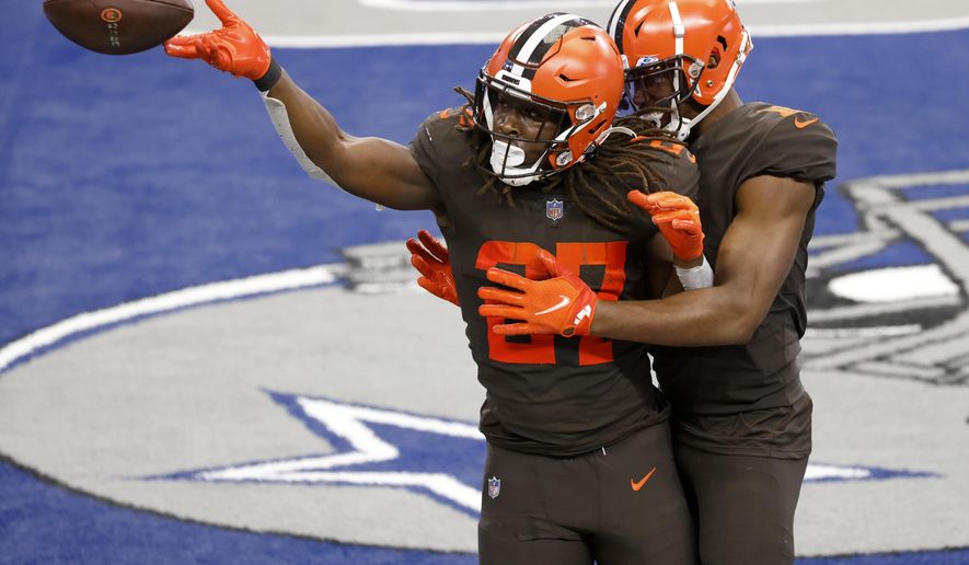 Cleveland Browns running back Kareem Hunt (27) and wide receiver Donovan Peoples-Jones, right, celebrate a touchdown scored by Hunt in the second half of an NFL football game against the Dallas Cowboys in Arlington, Texas, Sunday, Oct. 4, 2020. (AP Photo/Ron Jenkins)