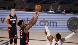 Miami Heat&#39;s Jimmy Butler (22) shoots against Los Angeles Lakers&#39; Kyle Kuzma (0) during the second half in Game 3 of basketball&#39;s NBA Finals, Sunday, Oct. 4, 2020, in Lake Buena Vista, Fla. (AP Photo/Mark J. Terrill)