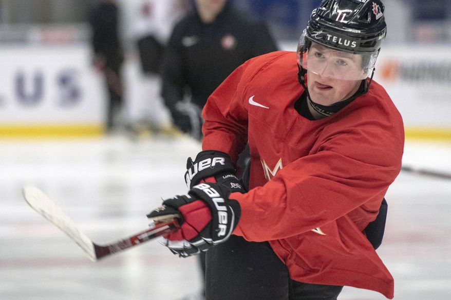 In this Jan. 1, 2020, file photo, Canada's Alexis Lafreniere shoots during the team's practice at the World Junior Hockey Championships in Ostrava, Czech Republic. The New York Rangers might be on the clock in owning the No. 1 pick in the NHL draft on Tuesday, Oct. 6. That, and the prospect of selecting Quebec star forward Alexis Lafreniere, doesn't mean the still-retooling Rangers will be anywhere closer to being a contender, team president John Davidson cautions. (Ryan Remiorz/The Canadian Press via AP, File) **FILE**