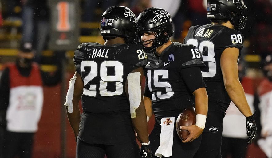 Iowa State quarterback Brock Purdy (15) celebrates with teammate Breece Hall (28) after scoring on a 2-yard touchdown run during the second half an NCAA college football game against Oklahoma, Saturday, Oct. 3, 2020, in Ames, Iowa. Iowa State won 37-30. (AP Photo/Charlie Neibergall)