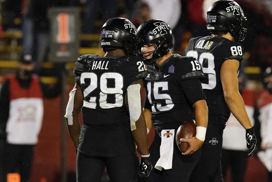 Iowa State quarterback Brock Purdy (15) celebrates with teammate Breece Hall (28) after scoring on a 2-yard touchdown run during the second half an NCAA college football game against Oklahoma, Saturday, Oct. 3, 2020, in Ames, Iowa. Iowa State won 37-30. (AP Photo/Charlie Neibergall)