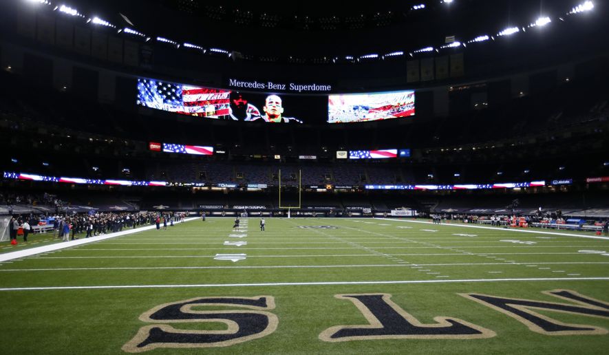 The New Orleans Saints stand for the National Anthem while the Green Bay Packers did not take to the field until after the Anthem, before an NFL football game in New Orleans, Sunday, Sept. 27, 2020. (AP Photo/Butch Dill)