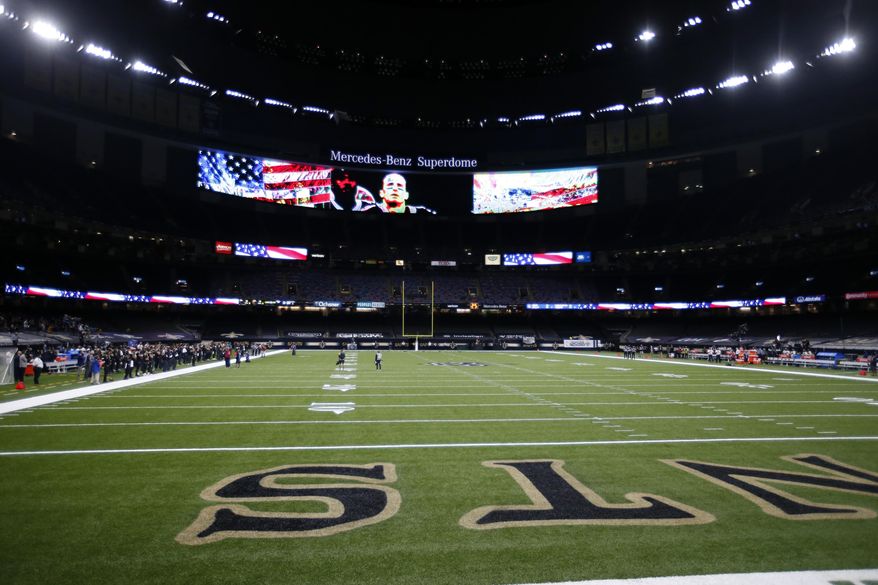 The New Orleans Saints stand for the National Anthem while the Green Bay Packers did not take to the field until after the Anthem, before an NFL football game in New Orleans, Sunday, Sept. 27, 2020. (AP Photo/Butch Dill)