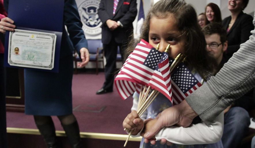 Victoria Dallas Fischer, 4, a child adopted from Guatemala, partially hides her face behind a handful of mini American flags as she goes to receive her citizenship certificate during the U.S. Citizenship and Immigration Services (USCIS) first ever Adoption Day ceremony on Thursday, Nov. 18, 2010, in New York.  In recognition of November as National Adoption Month, USCIS naturalized 17 adopted children from six countries; China, Ethiopia, Guatemala, Haiti, Saint Lucia, and South Korea, so that they may celebrate their first Thanksgiving with their families as American citizens.  (AP Photo/Bebeto Matthews)