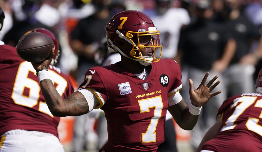 Washington Football Team quarterback Dwayne Haskins (7) tosses a pass during the first half of the Baltimore Ravens Washington Football team NFL football game Sunday, Oct. 4, 2020, in Landover, Md. (AP Photo/Steve Helber)