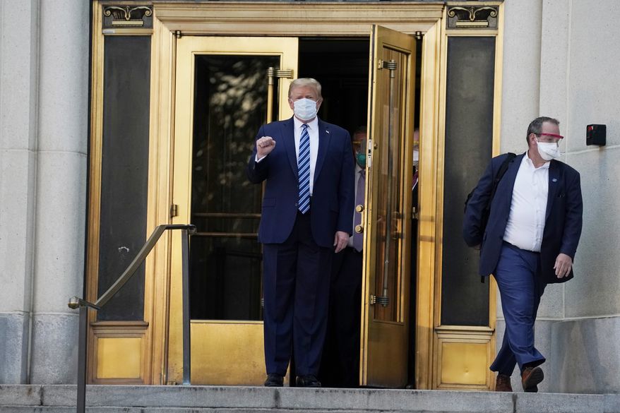 President Donald Trump walks out of Walter Reed National Military Medical Center to return to the White House after receiving treatments for covid-19, Monday, Oct. 5, 2020, in Bethesda, Md. (AP Photo/Evan Vucci)