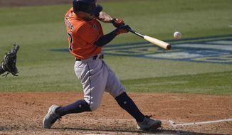 Houston Astros&#39; Jose Altuve hits a two-run single against the Oakland Athletics during the sixth inning of Game 1 of a baseball American League Division Series in Los Angeles, Monday, Oct. 5, 2020. (AP Photo/Ashley Landis)