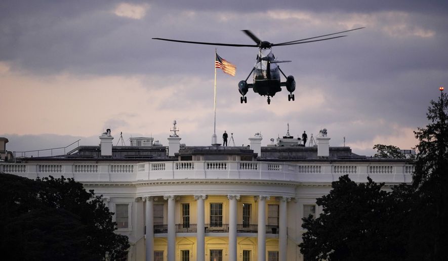 President Donald Trump arrives back at the White House aboard Marine One, Monday evening, Oct. 5, 2020 in Washington, after being treated for COVID-19 at Walter Reed National Military Medical Center. The president&#x27;s personal physician, Dr. Sean Conley, told reporters on Monday afternoon that Trump is not out of the woods yet, but that there is no care at the hospital that the president cannot get at the White House. (AP Photo/J. Scott Applewhite)