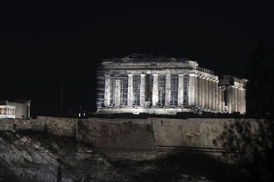 A new lighting system illuminates the ancient Acropolis hill in Athens, Wednesday, Sept. 30, 2020. Ancient temples on the Acropolis are illuminated after a new lighting system was installed and launched. The lower-energy LED lighting fixtures will light up more parts of the ancient site and is also intended to reduce light pollution with better-targeted lighting. (AP Photo/Yorgos Karahalis)