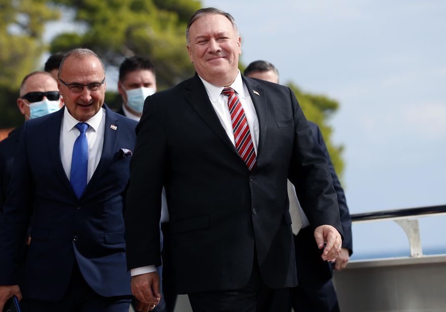 In this Oct. 2, 2020, file photo, U.S. Secretary of State Mike Pompeo, right, with Croatia&#39;s Foreign Minister Gordan Grlic Radman, arrives for a press conference after talks in Dubrovnik, Croatia. The foreign ministers from four Indo-Pacific nations known as the Quad group will gather in Tokyo Wednesday for talks in hopes of stepping up their cooperation and take leadership in a regional initiative to counter China’s growing assertiveness and influence. On his way to Tokyo, Pompeo told traveling reporters that the four countries have been preparing and hoped to have some “significant achievements” at the meeting, but he did not elaborate. (AP Photo/Darko Bandic, File)