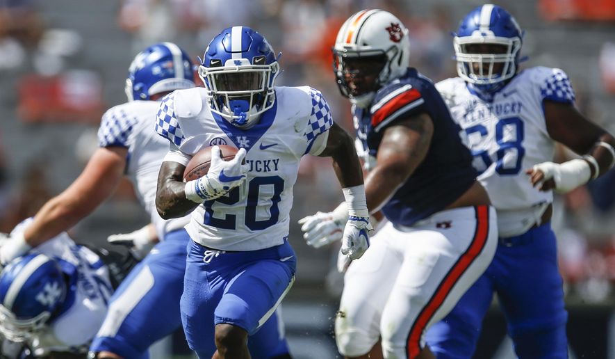 Kentucky running back Kavosiey Smoke (20) breaks free and carries the ball in for a touchdown against Auburn during the first quarter of an NCAA college football game on Saturday, Sept. 26, 2020 in Auburn, Ala. (AP Photo/Butch Dill)