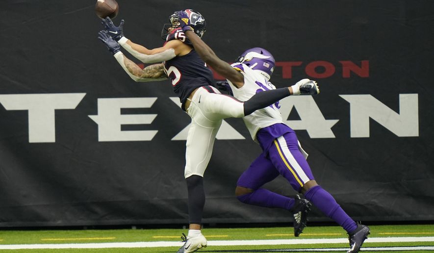 Houston Texans wide receiver Will Fuller (15) bobbles a catch in the end zone as Minnesota Vikings defensive back Holton Hill (24) defends the play during the second half of an NFL football game Sunday, Oct. 4, 2020, in Houston. (AP Photo/David J. Phillip)