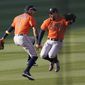 Houston Astros&#39; Carlos Correa, left, and George Springer celebrate after the Astros defeated the Oakland Athletics in Game 2 of a baseball American League Division Series in Los Angeles, Tuesday, Oct. 6, 2020. (AP Photo/Ashley Landis)