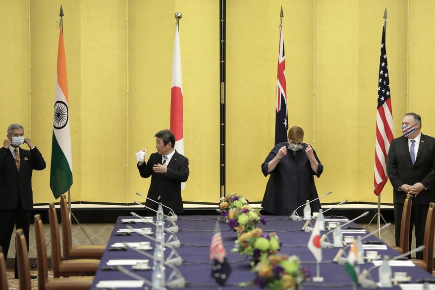 From left; India Foreign Minister Subrahmanyam Jaishankar, Japan Foreign Minister Toshimitsu Motegi, Australia Foreign Minister Marise Payne and U.S. Secretary of State Mike Pompeo remove their protective face masks before posing for a photograph prior to the Quadrilateral Security Dialogue (Quad) ministerial meeting in Tokyo, Tuesday, Oct. 6, 2020. (Kiyoshi Ota/Pool Photo via AP)