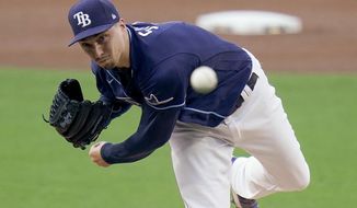 Tampa Bay Rays pitcher Blake Snell (4) delivers against New York Yankees&#39; DJ LeMahieu during the first inning in Game one of a baseball American League Division Series Monday, Oct. 5, 2020, in San Diego. (AP Photo/Jae C. Hong)