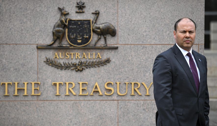 Australia&#39;s Treasurer Josh Frydenberg is photographed outside The Treasury in Canberra, Monday, Oct. 5, 2020. The Australian government will reveal a big spending financial blueprint for the next few years that will drive business investment and job creation while repairing pandemic damage to the economy. (Mick Tsikas/AAP Image via AP)