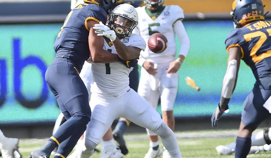 West Virginia linebacker Tony Fields II (1) breaks up the pass intended for Baylor running back Trestan Ebner (1) during an NCAA college football game, Saturday, Oct. 3, 2020, in Morgantown, W.Va. (William Wotring/The Dominion-Post via AP)