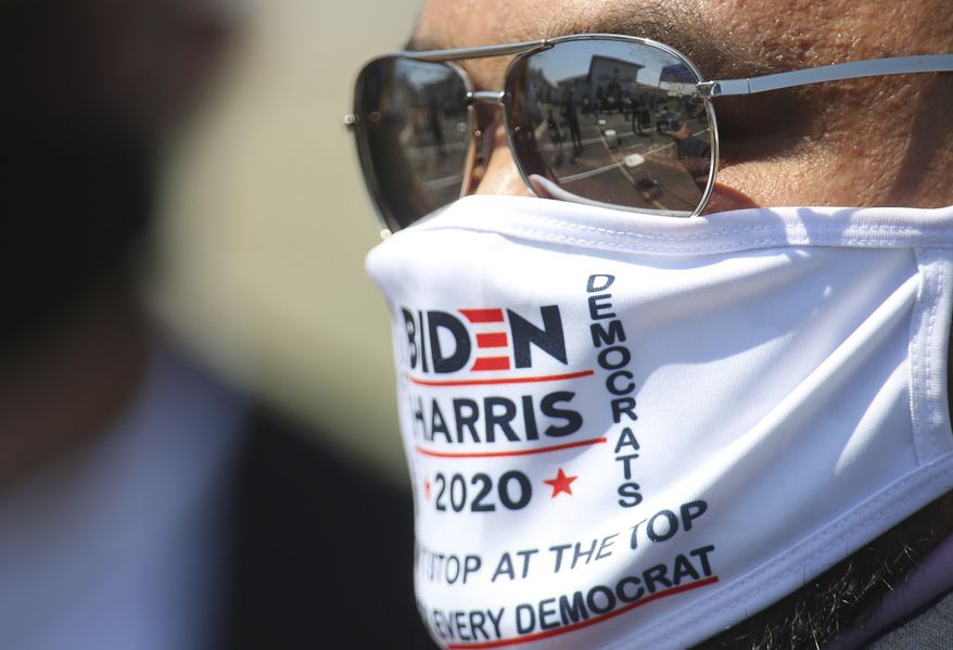 A supporter waits for U.S. Vice President candidate Kamala Harris' husband Douglas Emhoff to speak at a Hidalgo County Democratic Party Voter Registration Drive on Monday, Oct. 5, 2020, in Edinburg, Texas. (Joel Martinez/The Monitor via AP)
