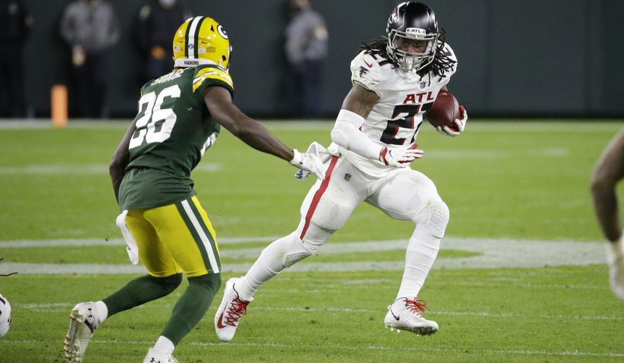 Atlanta Falcons' Todd Gurley (21) runs against Green Bay Packers' Darnell Savage (26) during the second half of an NFL football game, Monday, Oct. 5, 2020, in Green Bay, Wis. (AP Photo/Mike Roemer)